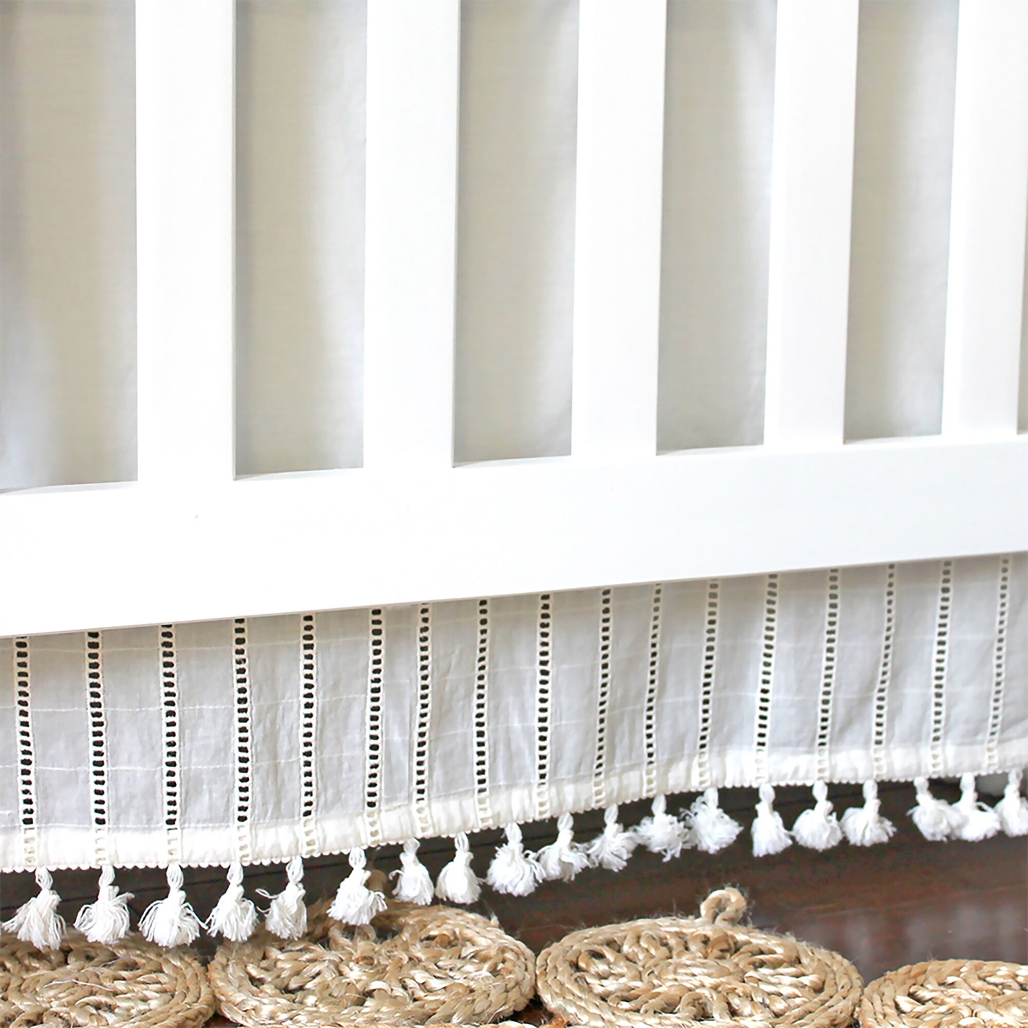 Crane baby bed skirt shown in lifestyle setting to demonstrate use